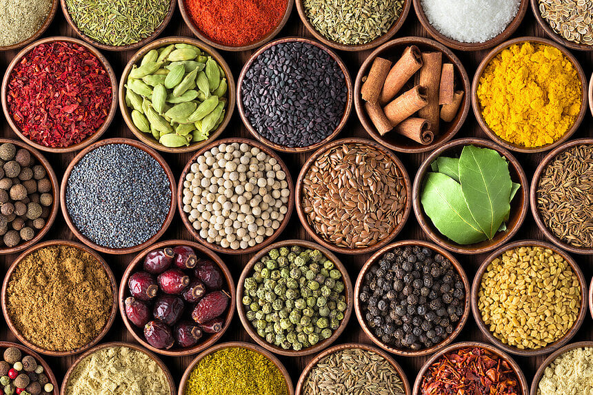 Colourful various herbs and spices for cooking on dark background